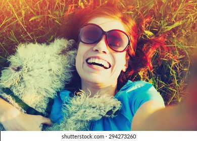 Young Woman Taking Selfie With Her Dog
