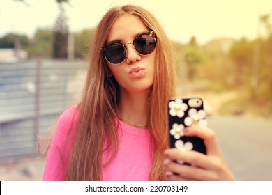 Young Woman Taking A Selfie Outdoors On Sunny Summer Day. Photo Toned Style Instagram Filters