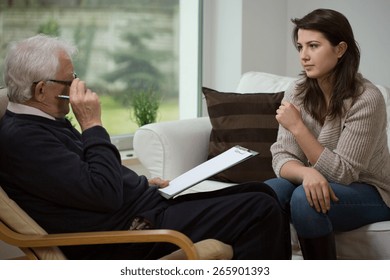 Young woman talking with her older psychologist