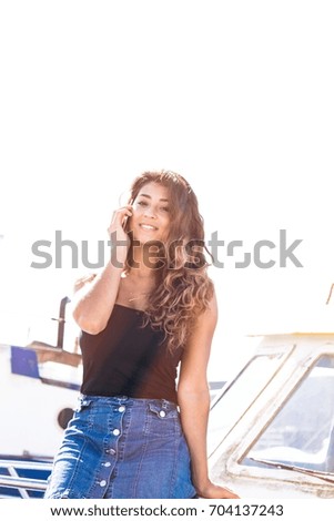 Similar – Young surfer woman with top and bikini kissing surfboard