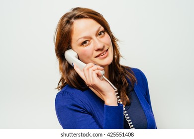 Young Woman Talking On The Landline Phone, Isolated On White