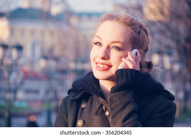 Young Woman Talking On Mobile Phone On The Street