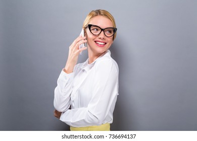 Young Woman Talking On The Phone On A Solid Background