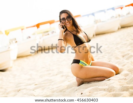 Similar – Brunette surfer woman with top and bikini holding surfboard