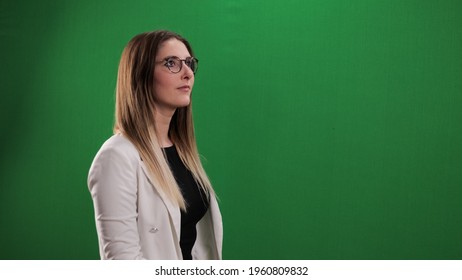 Young woman taps on a large imaginary touchscreen - studio photography - Powered by Shutterstock