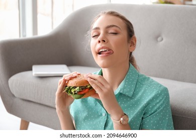 Young Woman With Tasty Vegan Burger At Home