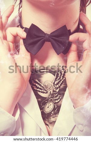 Young woman with tattoos and a bow tie. Tatto background collage