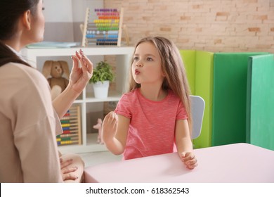 Young woman teacher and little girl on private lesson