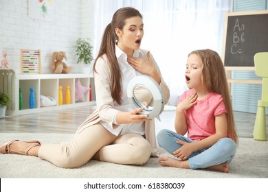 Young woman teacher and little girl on private lesson