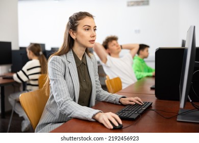 Young Woman Teacher Using PC During Computer Science Lesson.