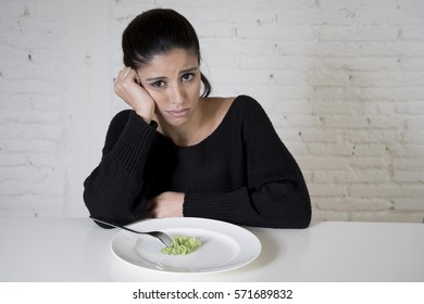 Young Woman Or Teen With Fork Eating Dish With Ridiculous Little Lettuce As Her Food Symbol Of Crazy Diet In Nutrition Disorder Concept Anorexia And Bulimia Refusing To Eat In Diet Calories Obsession 