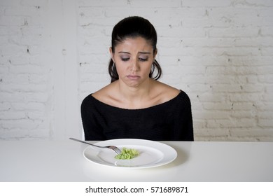 Young Woman Or Teen With Fork Eating Dish With Ridiculous Little Lettuce As Her Food Symbol Of Crazy Diet In Nutrition Disorder Concept Anorexia And Bulimia Refusing To Eat In Diet Calories Obsession 