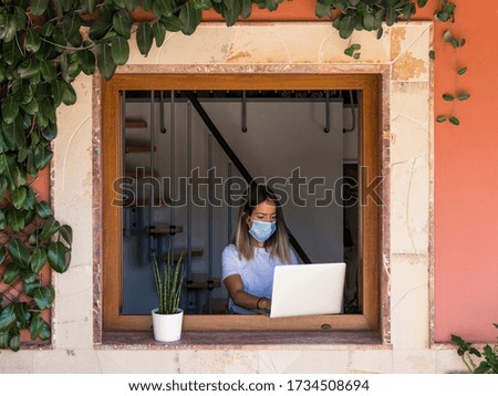 young woman teleworking with face mask