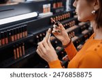 Young woman testing cosmetics in make-up store