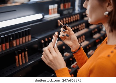 Young woman testing cosmetics in make-up store