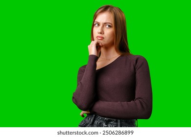 Young Woman Thinking With Hand On Chin Against Green Screen - Powered by Shutterstock