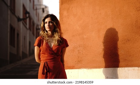 young woman thoughtful standing against a street wall - Powered by Shutterstock