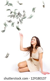 Young woman throwing 100 dollar bills up isolated on white