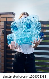 Young Woman Throwing Out Empty Used Plastic Water Bottles Into Trash Bin. Collecting Plastic Waste To Recycling. Concept Of Plastic Pollution And Too Many Plastic Waste. Environmental Issue