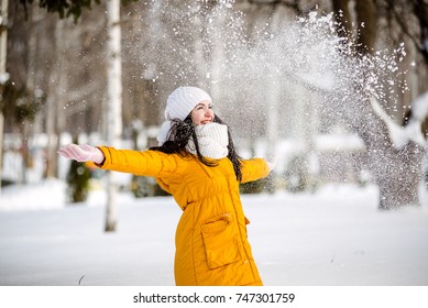 Young woman throwing snow, happy and fun
