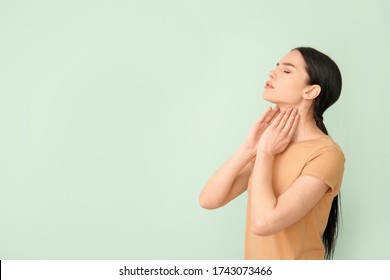 Young woman with thyroid gland problem on color background - Powered by Shutterstock