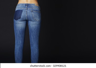 Young Woman In Tight Blue Jeans, Rear View