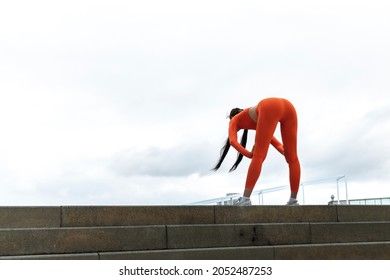 Young Woman Tired After Running. Female Athlete Bending Over Catching Her Breath Jogging.