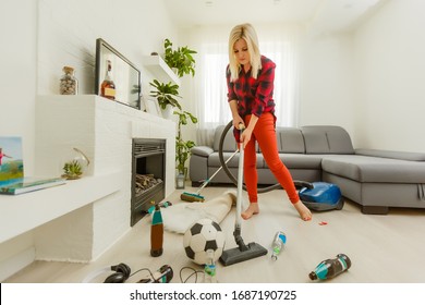 Young Woman Tired Of Spring Cleaning House, Washing Floor With Vacuum Cleaner In Messy Room, Copy Space