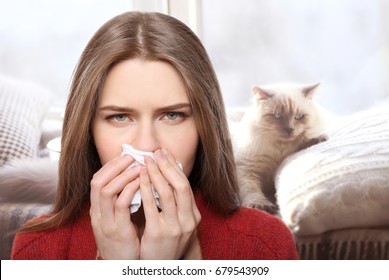 Young Woman With Tissue And Pet On Background. Concept Of Allergies To Cats