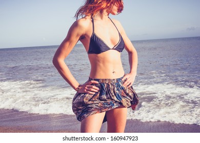 Young Woman With Toned Abs Standing On The Beach