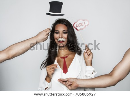 Young woman with top hat mustache and tie
