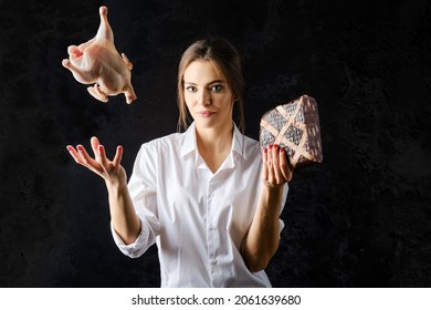 Young Woman Tossing Up Fresg Chicken With One Hand And Holding Meat Pie With Another