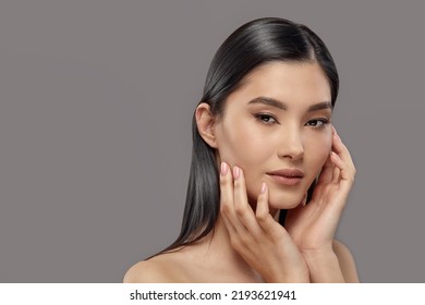 Young Woman Touching Clean Ideal Skin Of Her Face.