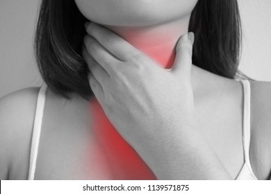 Young Woman Touching Her Neck.Gastro Esophageal Reflux Disease Concept.