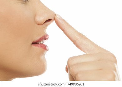 Young Woman Touching Her Nose With Her Finger