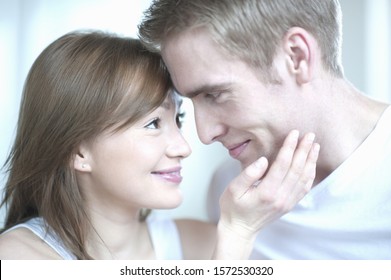 Young Woman Touching Man's Face, Close Up