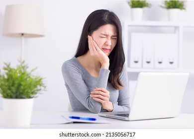 Young woman touching mouth with hand with painful expression because of toothache or dental illness on teeth - Powered by Shutterstock