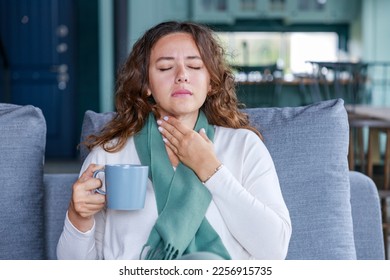 Young woman touching painful neck, sore throat for flu, cold and infection - Powered by Shutterstock