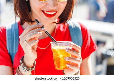 Young Woman Tourist Drinking Aperol Spritz At The City Street