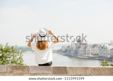Young woman tourist enjoying great citysacape view traveling in Budapest city, Hungary