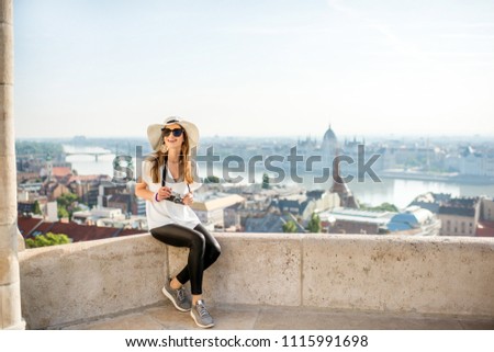 Young woman tourist enjoying great citysacape view traveling in Budapest city, Hungary