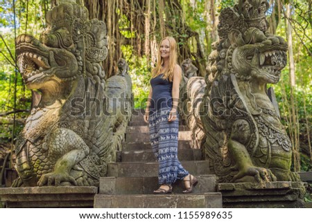 Young woman tourist explores the Monkey Forest in Ubud, Bali, Indonesia