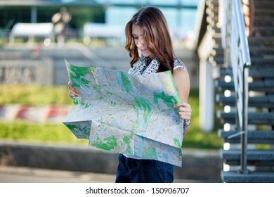 Young Woman Tourist Holding Paper Map Outdoors