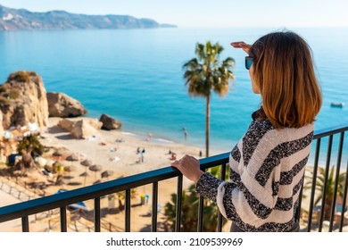 A young woman tourist on Calahonda beach in the town of Nerja, Andalusia. Spain. Costa del sol in the Mediterranean Sea.