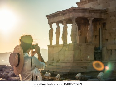 Young Woman Tourist Taking Pictures At Parthenon In Athens Acropolis, Greece