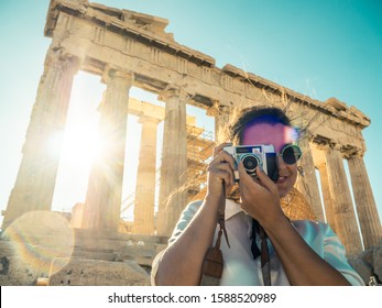 Young Woman Tourist Taking Pictures At Parthenon In Athens Acropolis, Greece