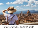 Young woman tourist watching Florence and Cathedral of Santa Maria Del Fiore. Vacation concept with view of Firenze, Italy from Piazzale Michelangelo