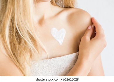 Young Woman In Towel After Shower Applying A Body Cream. Skin Care.