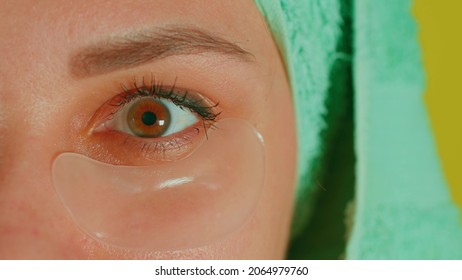 Young Woman With Towel On Head And Patches Under Her Eyes. Adult Female Courting Of Her Face In Domestic Conditions. Concept Of Fighting Wrinkles And Dark Circles Under Eyes. Close Up