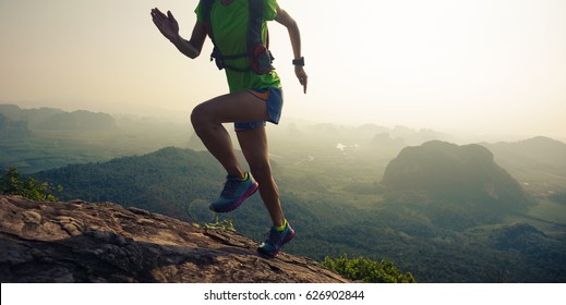 Young Woman Trail Runner Running  Up On Mountain Top